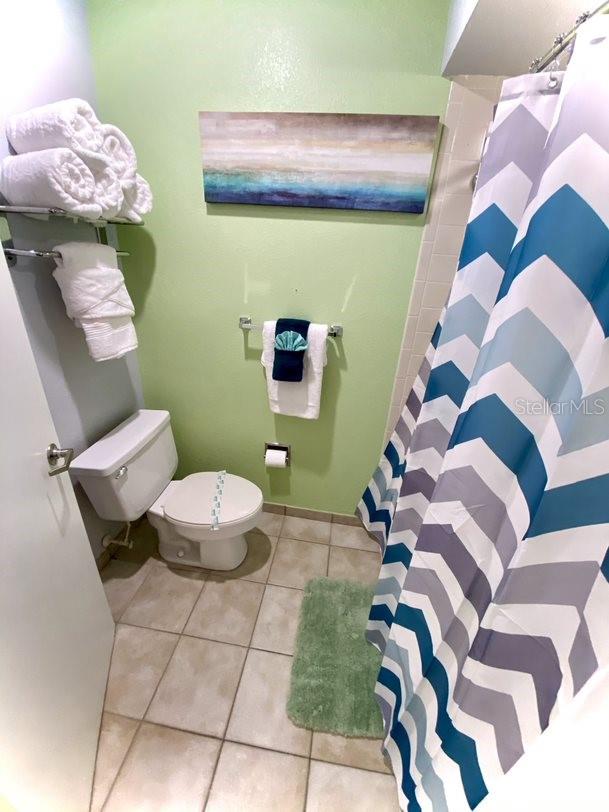 bathroom featuring toilet and tile patterned flooring