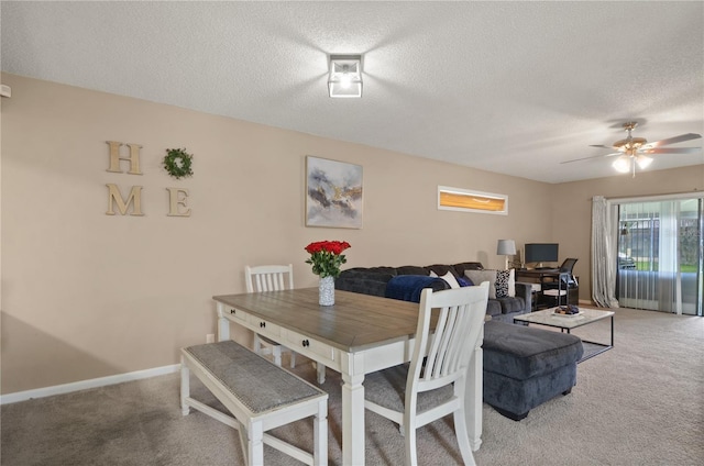 dining space with light carpet, a textured ceiling, a ceiling fan, and baseboards