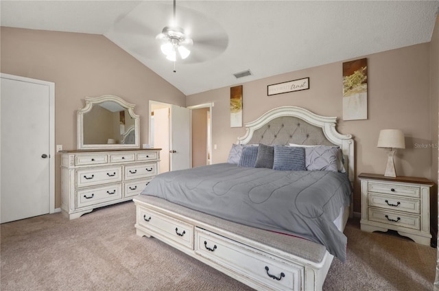 bedroom with a ceiling fan, light colored carpet, vaulted ceiling, and visible vents