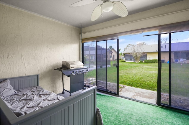 bedroom featuring access to outside, a textured wall, and ceiling fan