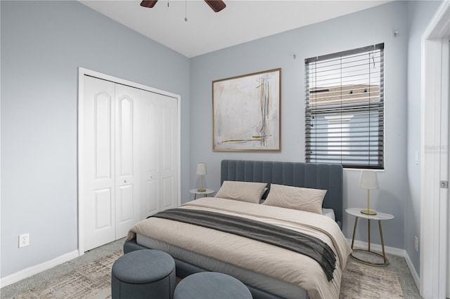 bedroom featuring carpet, baseboards, and a closet