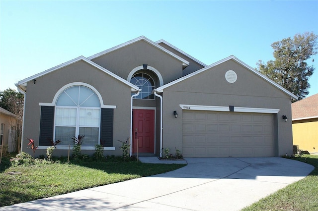 view of front of home featuring a garage and a front yard