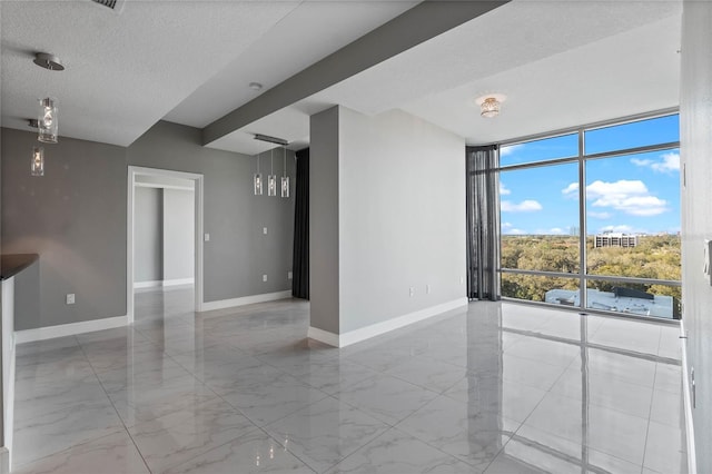 101 S Eola Dr Unit 1001, Orlando, FL 32801 - unfurnished room featuring a wall of windows, baseboards, marble finish floor, and a textured ceiling