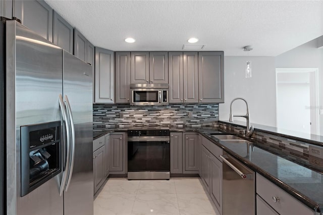 101 S Eola Dr Unit 1001, Orlando, FL 32801 - kitchen featuring marble finish floor, gray cabinets, appliances with stainless steel finishes, and a sink