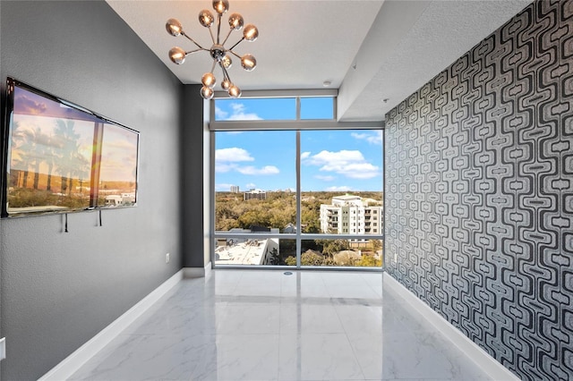 101 S Eola Dr Unit 1001, Orlando, FL 32801 - interior space featuring baseboards, a notable chandelier, marble finish floor, and floor to ceiling windows