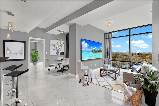 101 S Eola Dr Unit 1001, Orlando, FL 32801 - living room with baseboards, a textured ceiling, marble finish floor, and floor to ceiling windows