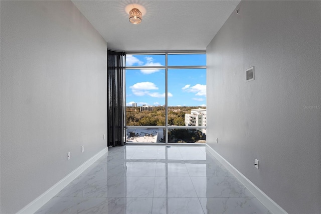 101 S Eola Dr Unit 1001, Orlando, FL 32801 - empty room with a wall of windows, baseboards, and marble finish floor