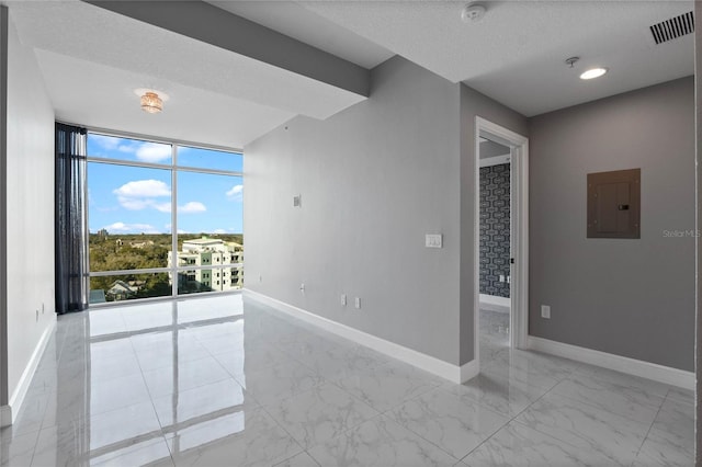 101 S Eola Dr Unit 1001, Orlando, FL 32801 - empty room with visible vents, marble finish floor, electric panel, expansive windows, and baseboards