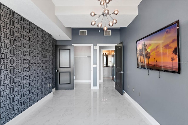 101 S Eola Dr Unit 1001, Orlando, FL 32801 - hall with visible vents, marble finish floor, an accent wall, and baseboards