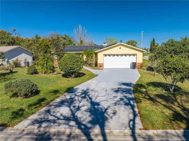 ranch-style house with a front yard, a garage, and solar panels