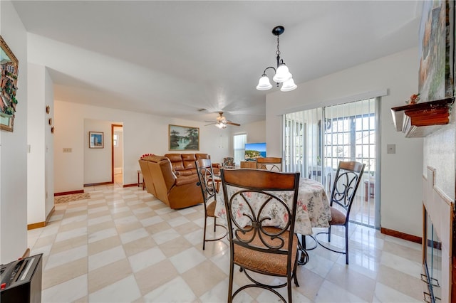 dining room with ceiling fan with notable chandelier