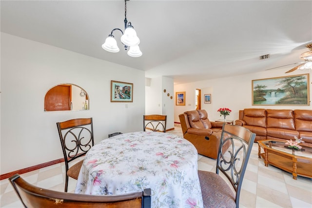 dining area with ceiling fan with notable chandelier