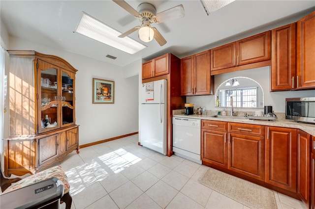 kitchen featuring sink, ceiling fan, white appliances, and light tile patterned flooring