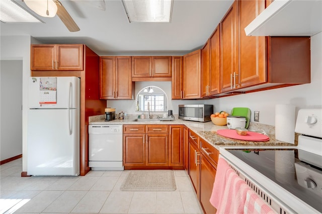 kitchen featuring white appliances, sink, light tile patterned flooring, range hood, and ceiling fan