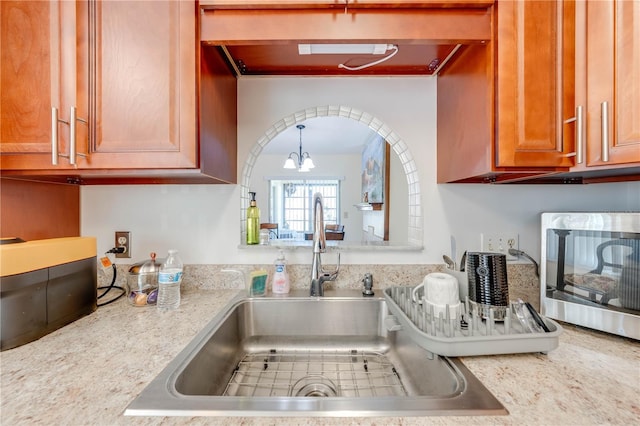 kitchen with sink and an inviting chandelier