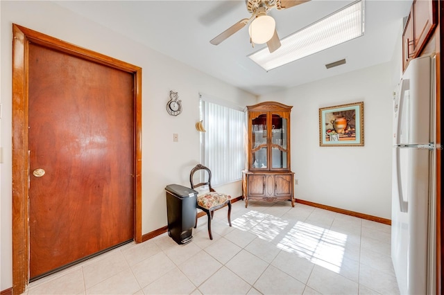 unfurnished room featuring ceiling fan and light tile patterned floors