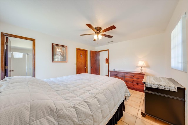 tiled bedroom featuring ceiling fan