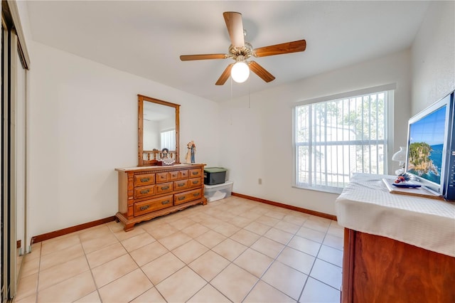 tiled bedroom featuring ceiling fan