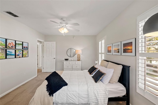 bedroom featuring baseboards, visible vents, a ceiling fan, and light colored carpet