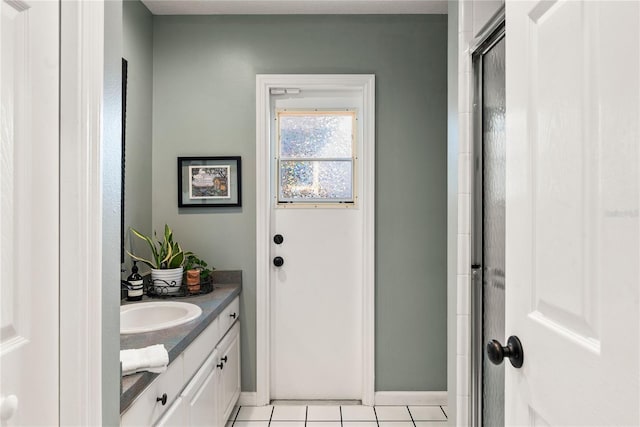 full bathroom with tile patterned flooring, vanity, baseboards, and an enclosed shower