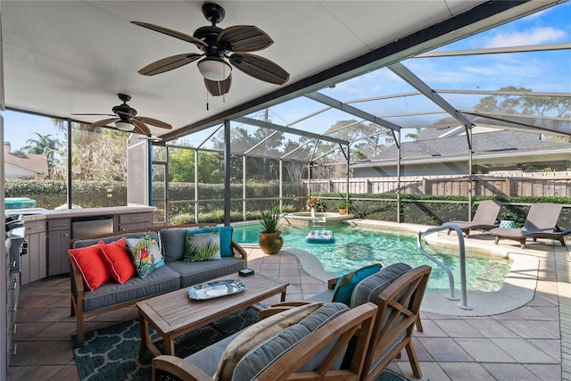 exterior space featuring glass enclosure, a pool with connected hot tub, an outdoor living space, a ceiling fan, and a patio area