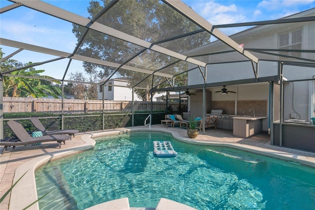 view of swimming pool featuring a patio, a sink, fence, a ceiling fan, and a fenced in pool