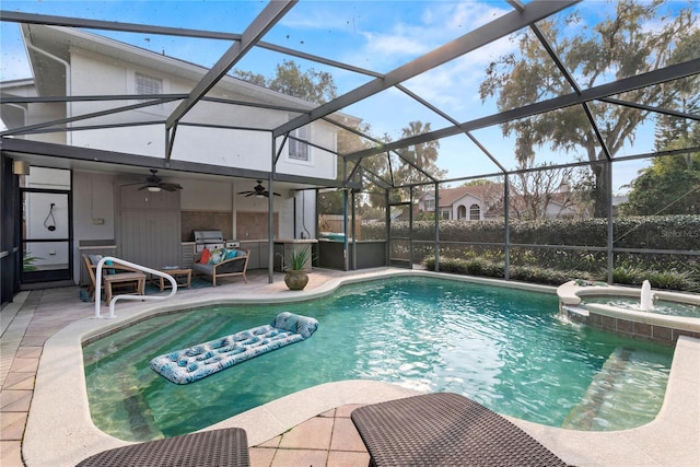 view of swimming pool featuring a ceiling fan, a patio, glass enclosure, a grill, and a pool with connected hot tub