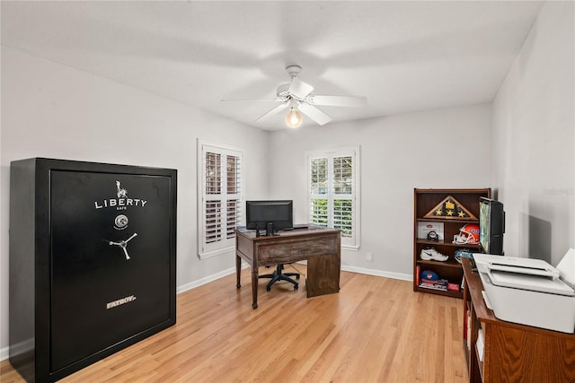 home office featuring light wood-type flooring, ceiling fan, and baseboards