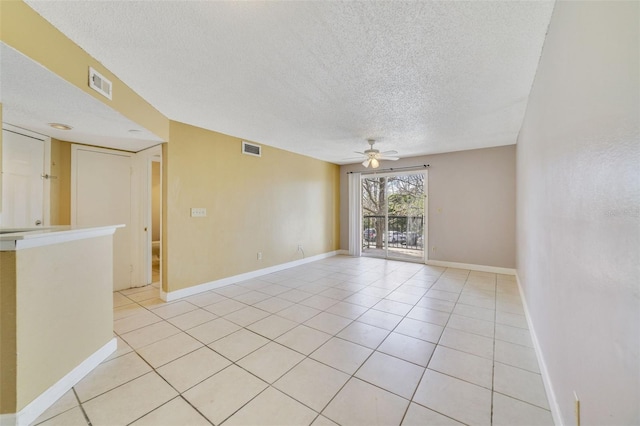 tiled spare room featuring ceiling fan and a textured ceiling