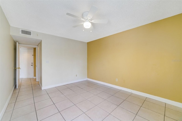 tiled spare room featuring ceiling fan and a textured ceiling