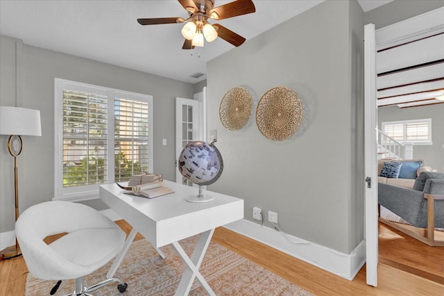 office space with wood-type flooring and ceiling fan