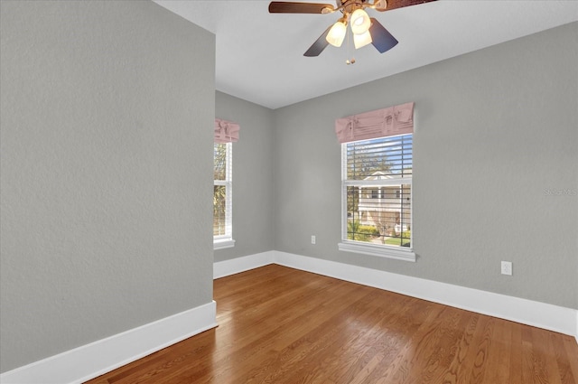 unfurnished room with ceiling fan and wood-type flooring