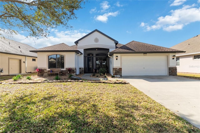 single story home with a garage and a front lawn