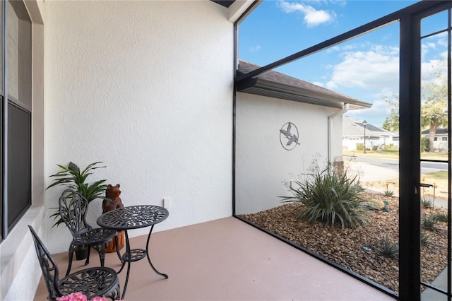 view of exterior entry with a patio area