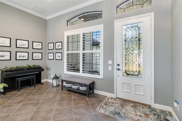 entrance foyer with tile patterned flooring and crown molding