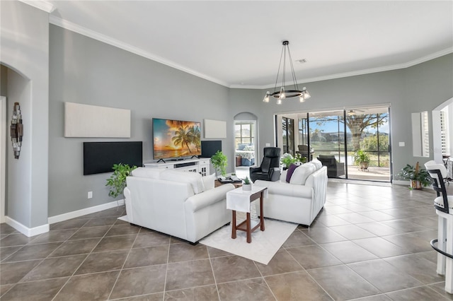 living room with a chandelier, tile patterned flooring, and ornamental molding