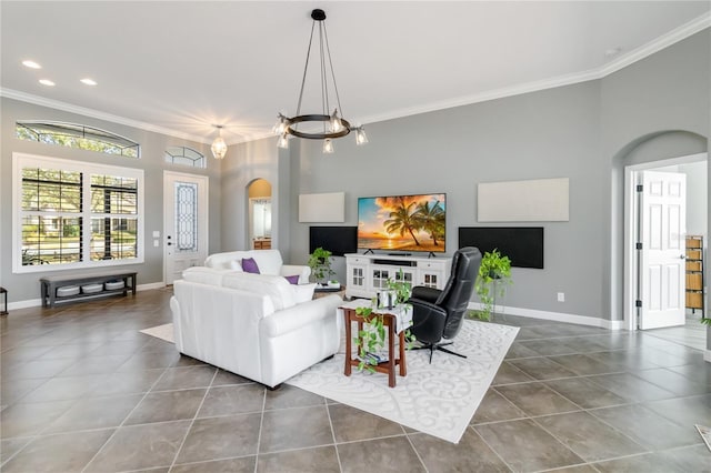 tiled living room featuring an inviting chandelier and ornamental molding