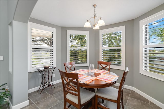 tiled dining area with an inviting chandelier