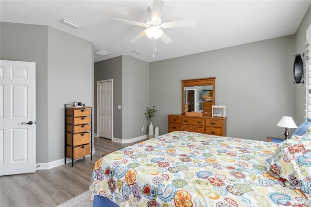 bedroom with ceiling fan, a closet, and light hardwood / wood-style floors