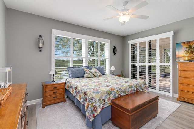 bedroom featuring ceiling fan, light wood-type flooring, and access to exterior