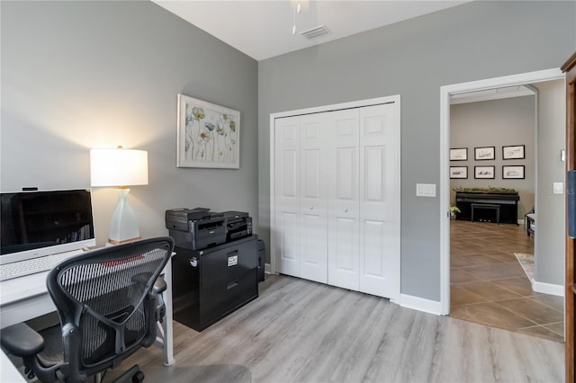 office area with ceiling fan and light wood-type flooring