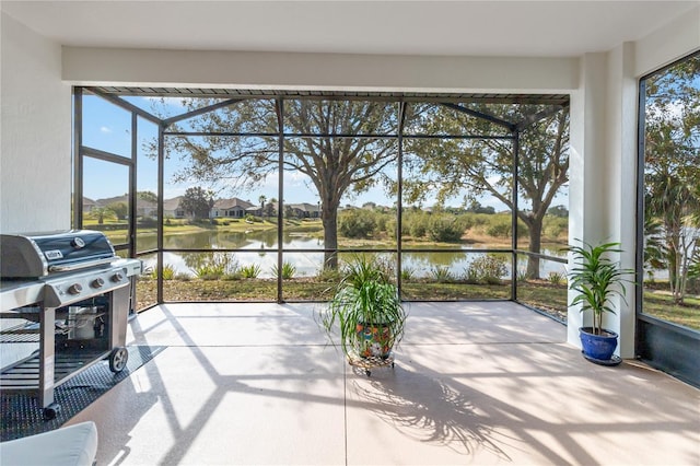 sunroom / solarium with a water view