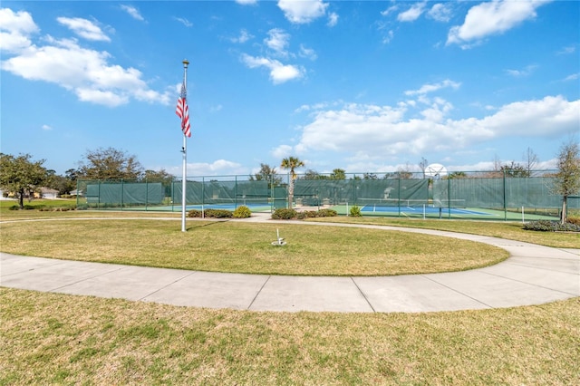 surrounding community featuring a yard and tennis court