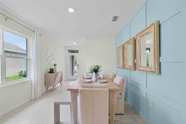 dining room with light tile patterned flooring and a healthy amount of sunlight