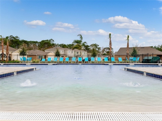 view of pool with pool water feature and a water view