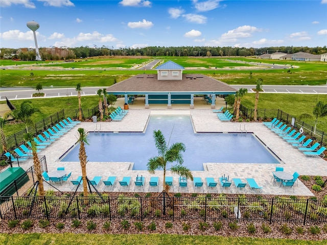 view of pool featuring a patio area and a yard