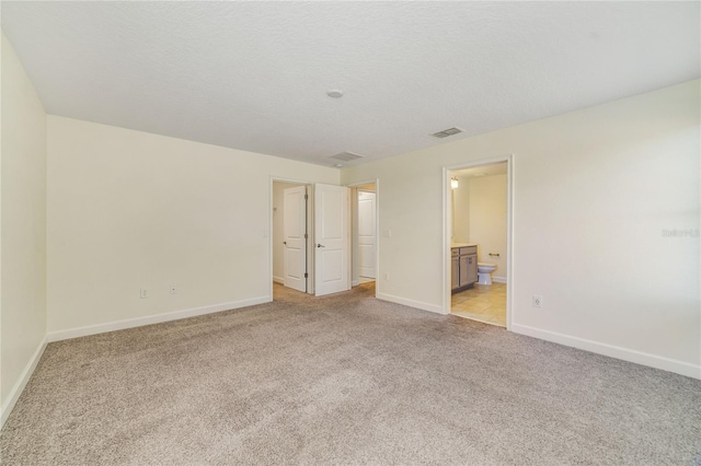 15088 Night Heron Dr, Winter Garden, FL 34787 - unfurnished bedroom featuring light colored carpet and ensuite bath