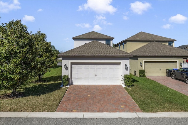 15088 Night Heron Dr, Winter Garden, FL 34787 - traditional-style home featuring an attached garage, a front lawn, decorative driveway, and stucco siding