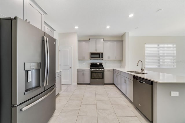 15088 Night Heron Dr, Winter Garden, FL 34787 - kitchen with stainless steel appliances, gray cabinets, a peninsula, light countertops, and recessed lighting