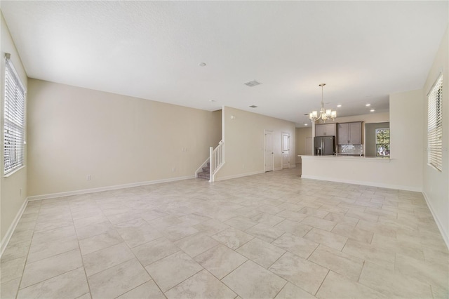 15088 Night Heron Dr, Winter Garden, FL 34787 - unfurnished living room with a chandelier, stairway, and recessed lighting